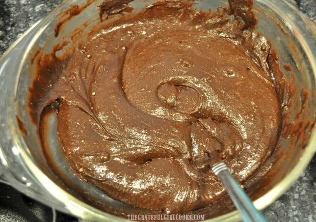 Batter for brownies is quickly mixed together in large bowl.