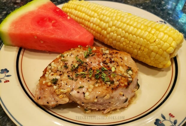Garlic butter pork chops, served with corn and watermelon on the side.
