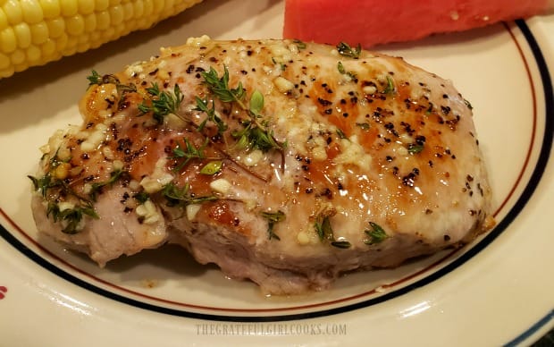 Fresh thyme sprigs garnish the finished garlic butter pork chops.