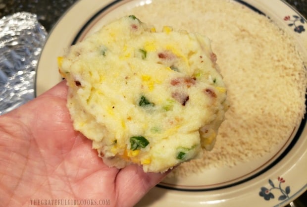 The loaded potato fritters are shaped into patties.