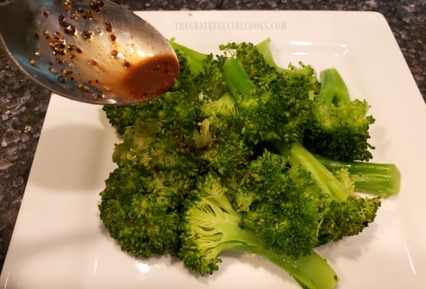 The balsamic vinaigrette is drizzled over the steamed broccoli.