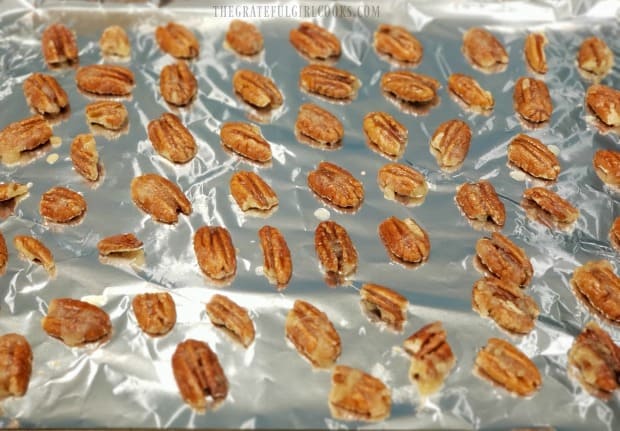 The nuts are laid in a single layer on a foil covered baking sheet prior to cooking.