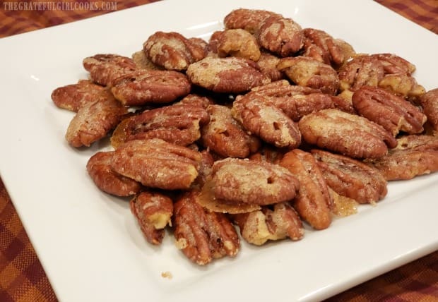 The sugared curry ginger pecans are transferred to a platter to serve.