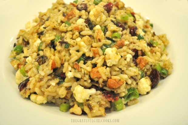 Wild rice salad in pumpkin vinaigrette served in a white bowl.