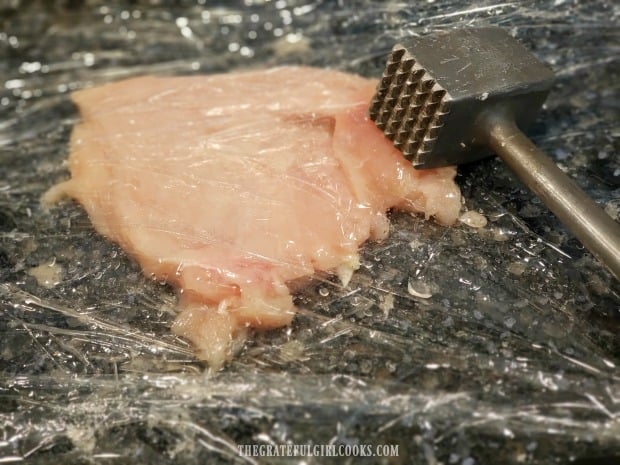 Boneless, skinless chicken breasts are flattened with a meat mallet before cooking.