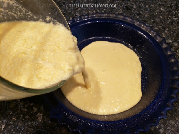 Coconut pie filling is poured into a greased pie pan.