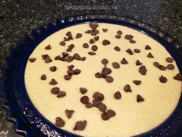 Chocolate chips are added to the pie filling, and then submerged.