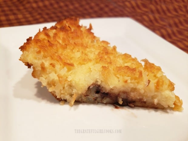 A slice of the coconut chocolate chip pie is served on a white plate.