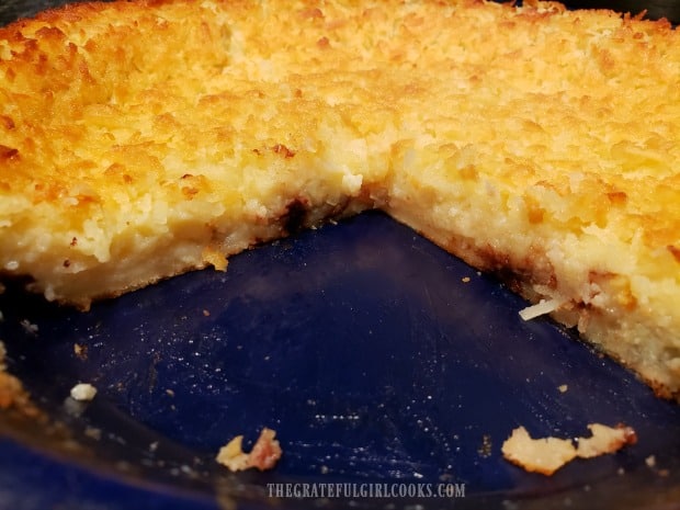 A look at the inside of a sliced into coconut pie in the pan.