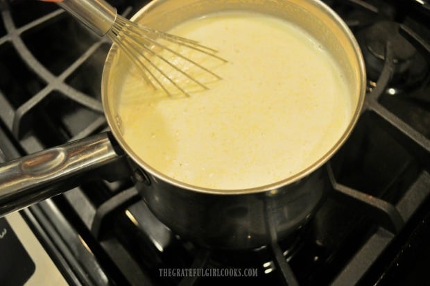 The polenta begins to thicken as it is whisked and cooked.