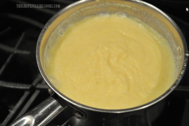 Creamy polenta in pan has thickened and is ready for the final ingredients.