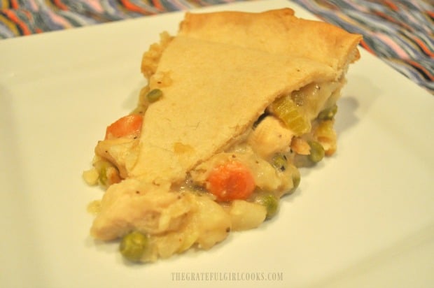A single serving of chicken pot pie on a white plate.