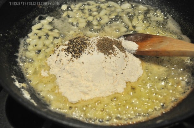 Onions are cooked, then flour and spices are added to skillet.