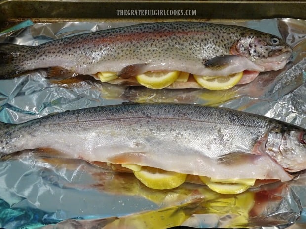 The trout is stuffed with garlic, lemon and butter before being grilled.