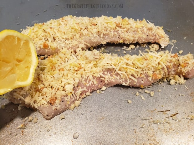 Olive oil and lemon juice are drizzled over crumb-topped fish fillets before baking.