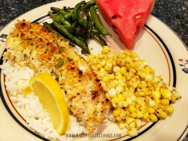 Garlic parmesan rockfish fillet on rice, with green beans, corn, and watermelon on the side.