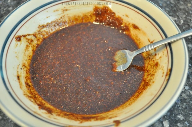 The chili basting sauce for chicken breasts is mixed together in a bowl.