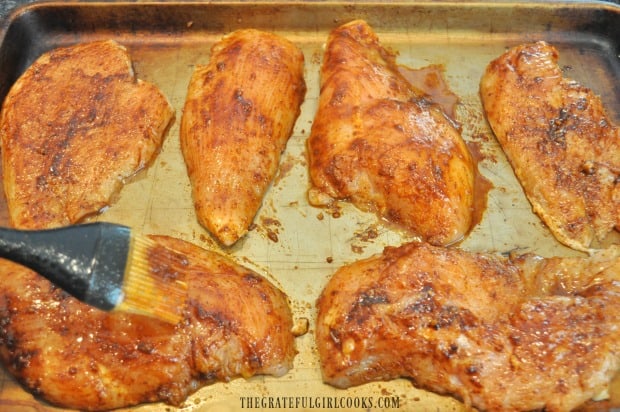 Sauce is brushed onto the chicken breasts before putting them in the smoker.