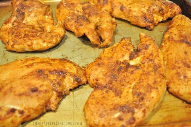 The Traeger chili smoked chicken breasts are removed after smoking and before grilling.