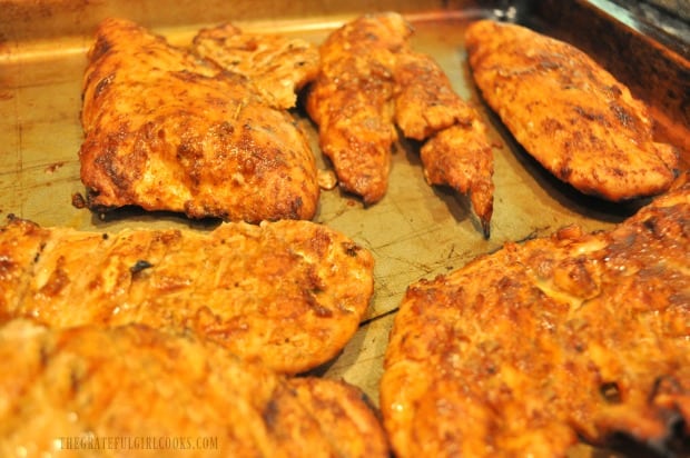 After grilling, the chili smoked chicken breasts rest before they are served.