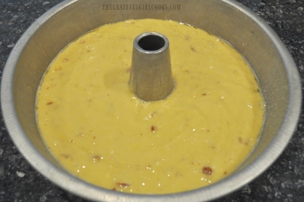 The batter is evenly dispersed in a tube pan before baking.