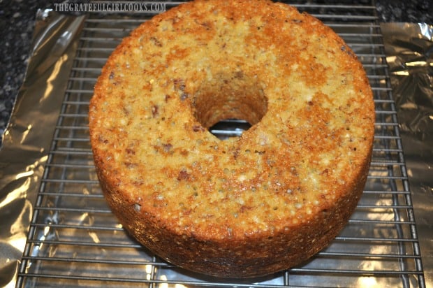 After cooling, the banana nut pound cake is inverted onto a wire rack.
