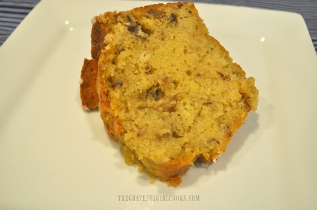 A single slice of banana nut pound cake, served on a white plate.