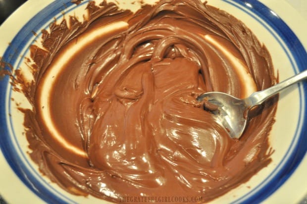 Chocolate chips are melted in the microwave until smooth and creamy.