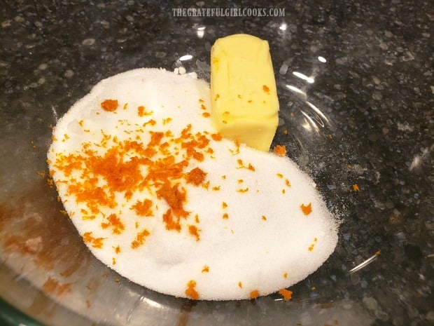 Butter, sugar and orange zest are creamed together for cake batter mixture.