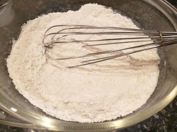 Flour, salt, and baking powder are whisked together for cake batter mix.