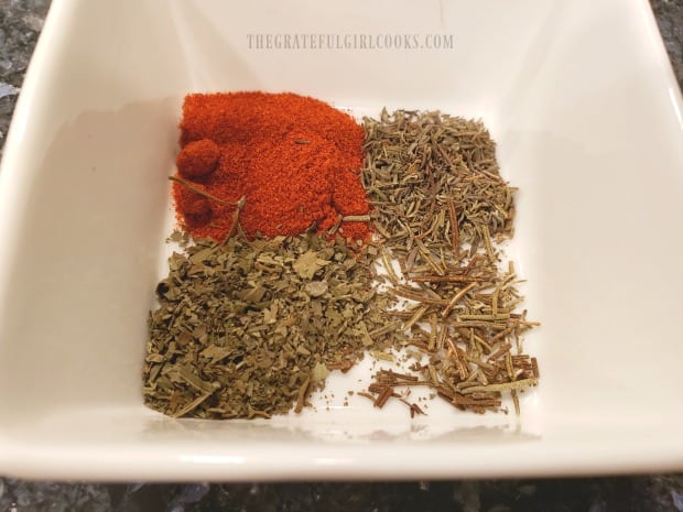 Paprika, thyme, basil, salt, pepper and rosemary are crushed for chicken seasoning mix.