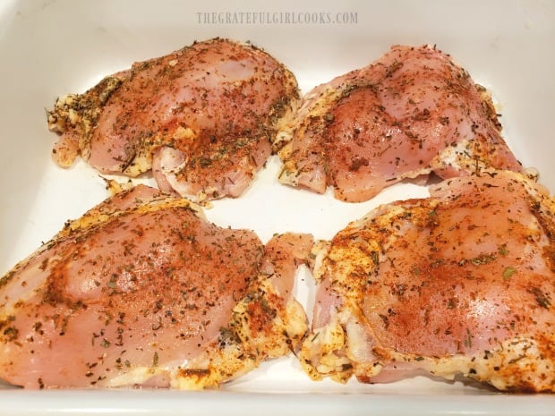 Four chicken thighs are rubbed on all sides with dry seasoning mix.