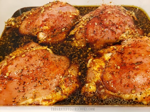 The chicken thighs are marinated in the sauce before baking.