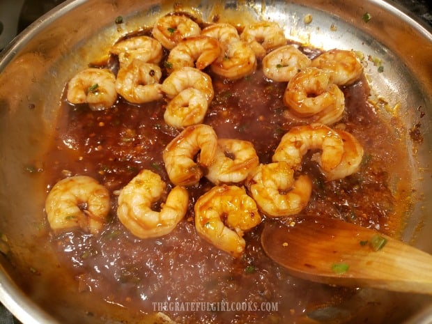 Asian sauce is added to the cooked shrimp, and heated through before serving.