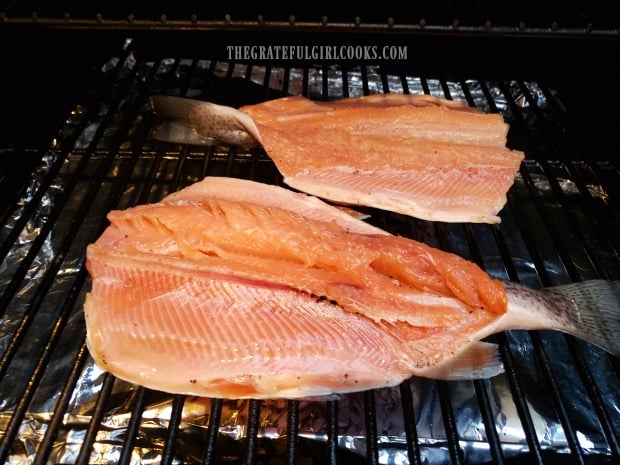 Traeger grill smoked trout is cooked skin side down on the grill.