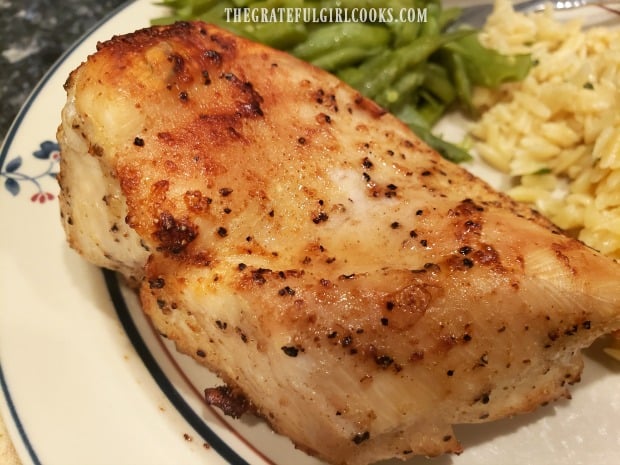 One of the air fryer chicken breasts in a close up photo.