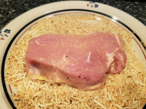 Pork chop with egg wash is then coated with seasoned bread crumb mixture.