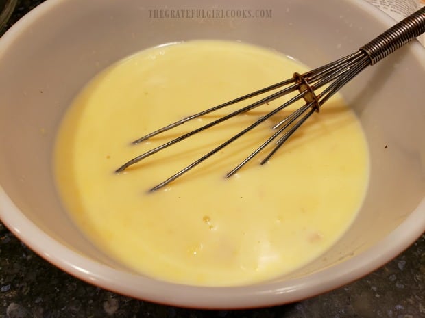 Cream of chicken soup and milk are combined to start making the sauce.