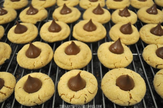 Peanut butter kiss cookies, cooling on a wire rack.