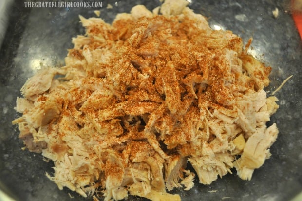 Cooked, shredded turkey is seasoned with taco seasoning.