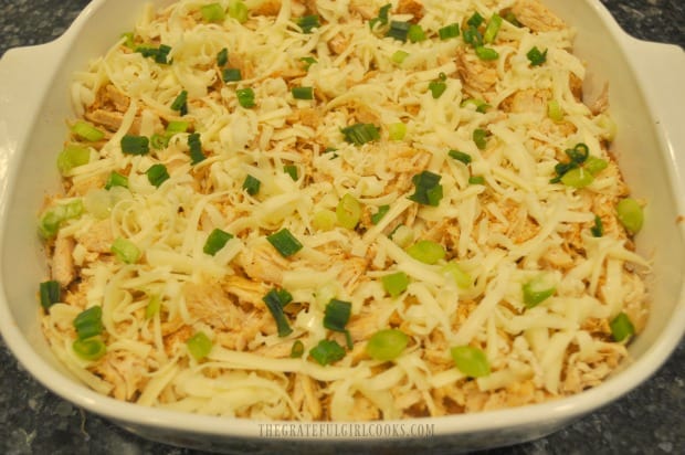 Turkey Fiesta Casserole is topped with jack cheese and green onions and then baked.