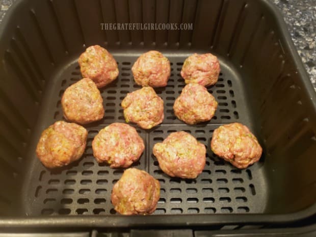 Air fryer Italian meatballs in the fryer, ready to be cooked.