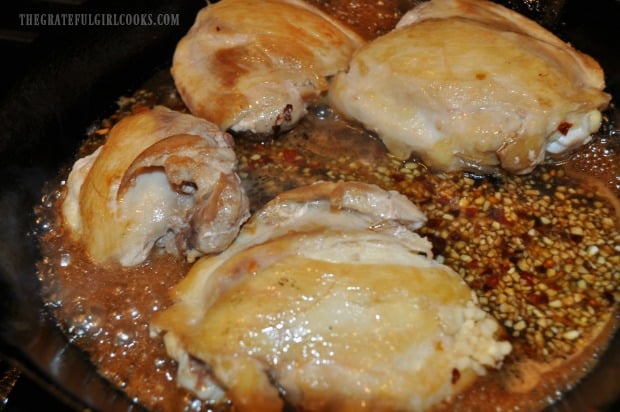 Garlic, red pepper flakes and sauce are added to the Asian Chicken Thigh Skillet.