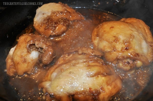 Asian Chicken Thigh Skillet is covered to let meat cook in sauce for 15 minutes.