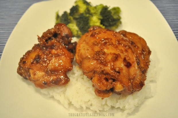 Finished Asian chicken thigh skillet dish is served on top of steamed rice.