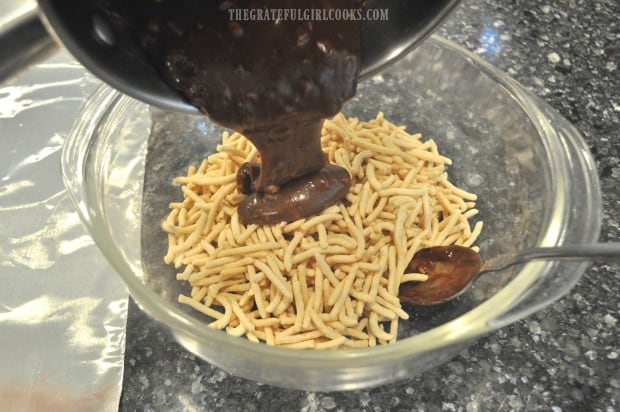 Melted caramel and chocolate mixture is poured over chow mein noodles.
