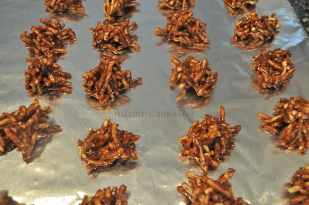 The chocolate caramel clusters are dropped by teaspoonfuls onto foil to firm up.