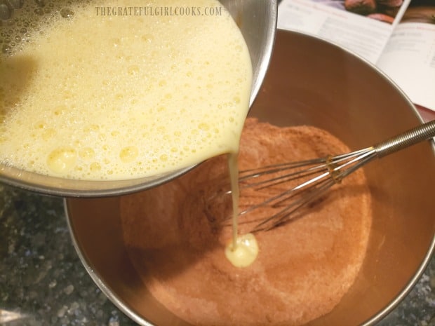 Wet ingredients for the chocolate espresso muffins are added to dry ingredients.