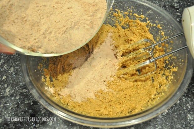 Dry ingredients are added to the batter for the mocha chocolate chip cookies.