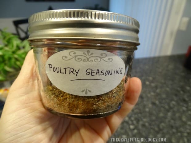 An airtight jar or container holds the poultry seasoning mix for storage.